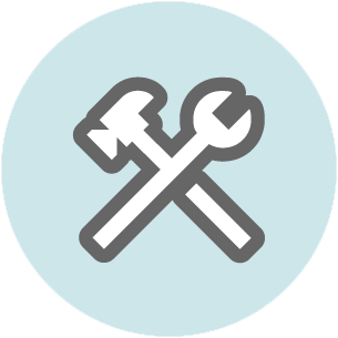 Crossed hammer and wrench tools on a light blue circular background.