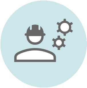 Gray icon showing a person wearing a hard hat with two gear symbols above, on a light blue circular background.